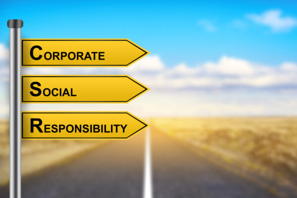 CSR or Corporate Social Responsibility words on yellow road sign with blurred background