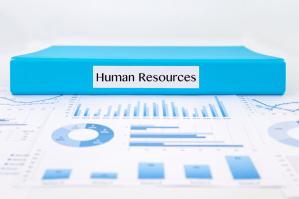 Blue document binder with Human Resources word place on graph analysis and business reports