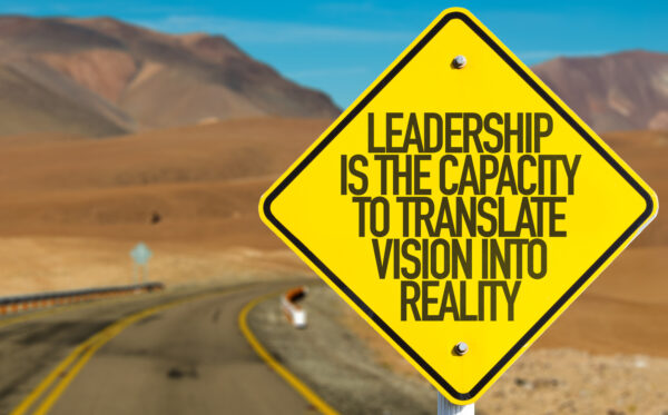 Leadership Is The Capacity To Translate Vision Into Reality sign on desert road