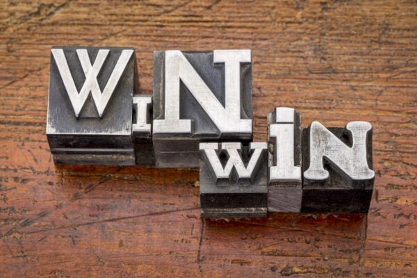 win-win strategy in mixed vintage metal type printing blocks over grunge wood