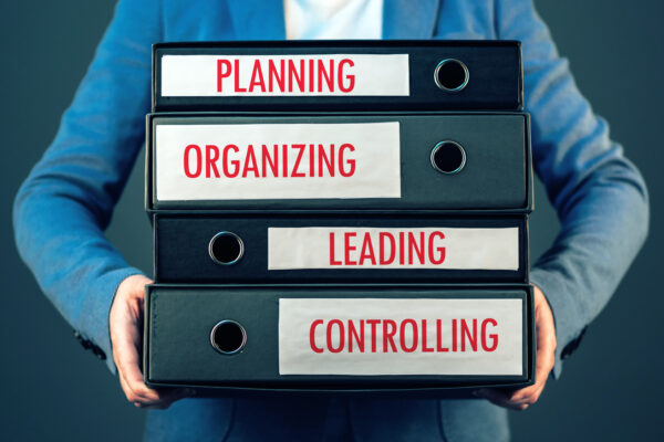 Four basic functions of management process in business organization - planning, organizing, leading and controlling.